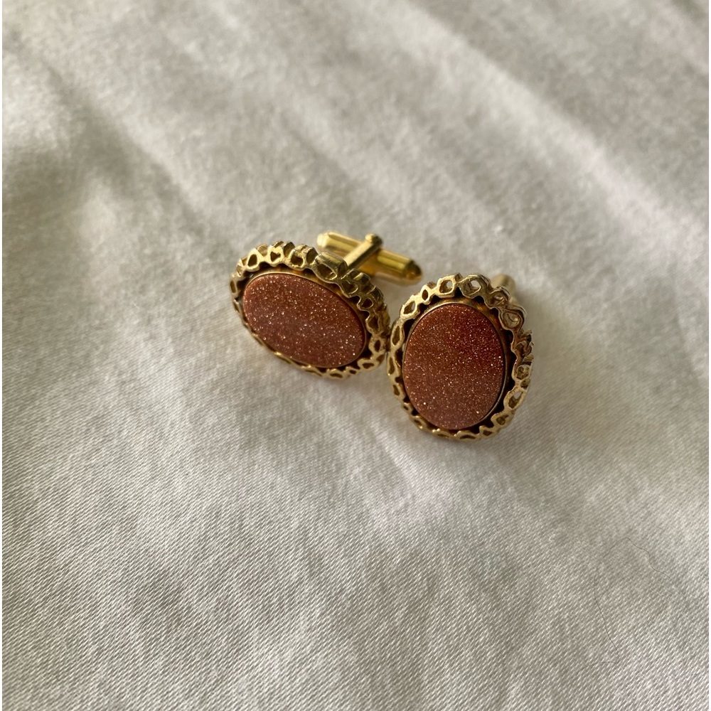 Sparkling copper stone & goldtone cuff links, delicate open weave edge.